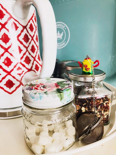 Tea station and jar of marshmallows with strainer